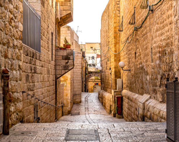 Israel - Jerusalem Old City Alley This pic shows Old narrow streets of  Old city jerusalem of Israel The pic shows Old streets and alley in jaffa of jerusalem. The pic is taken in day time and in January 2019. ancient arch architecture brick stock pictures, royalty-free photos & images