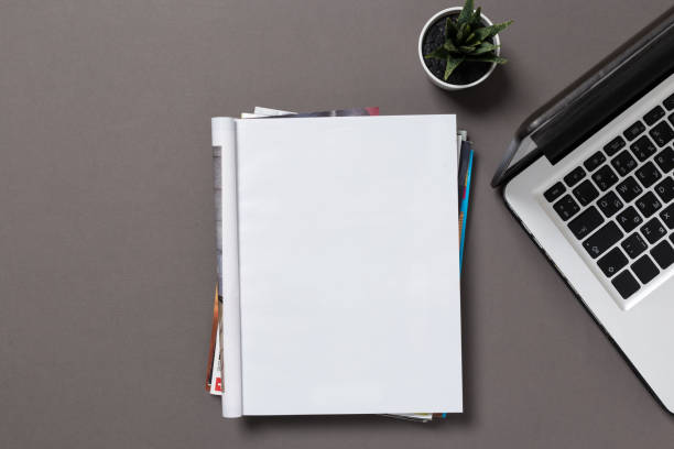 istock office desk top view with blank notebook  isolated on gray, with clipping path, changeable background. Blank page or notepad on wood background. Blank page or notepad for mockups or simulations. 1133127293