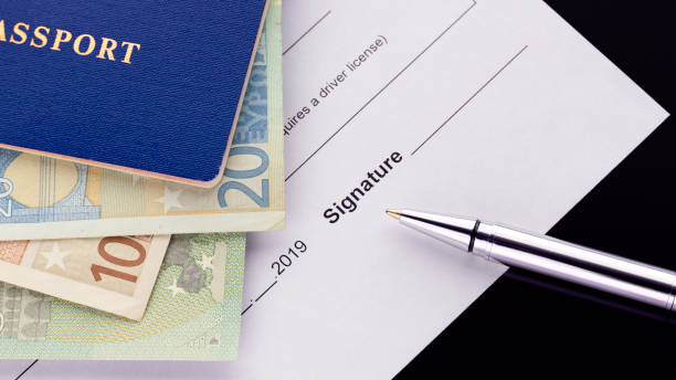 istock Signing a document. Blue passport with euro banknotes 1133129569
