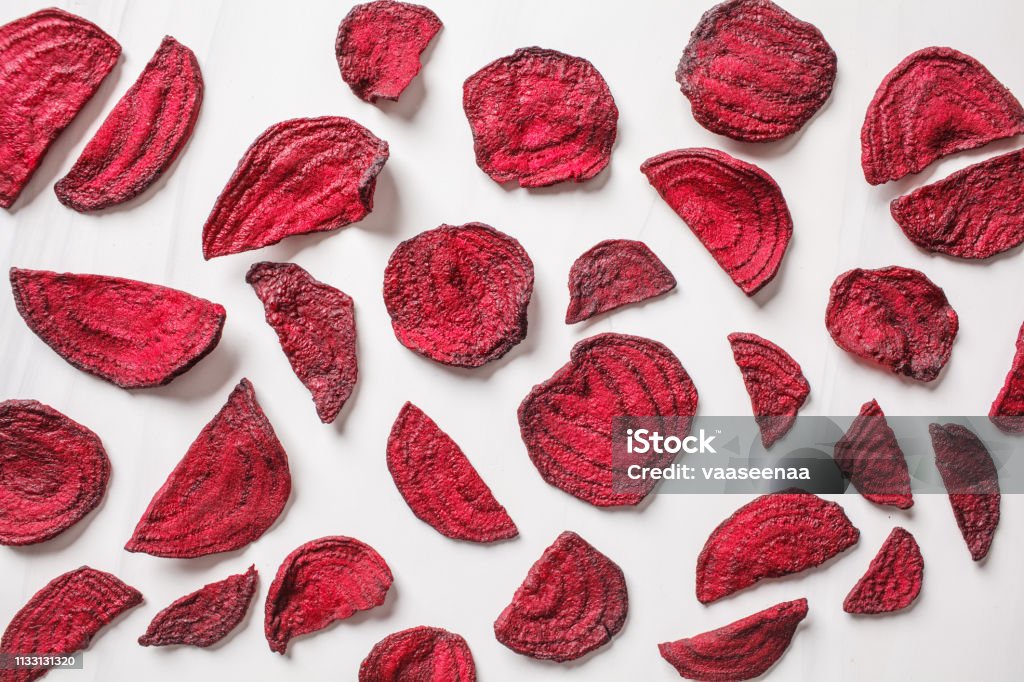 Dried beet chips on a white background, top view. Dried beetroot chips on a white background. Beet Stock Photo