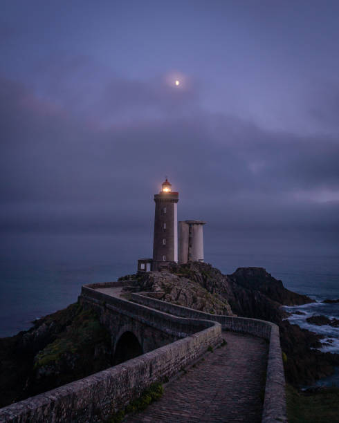 istock Isolated lighthouse path and moon over Petit Minou tower in France 1133132041
