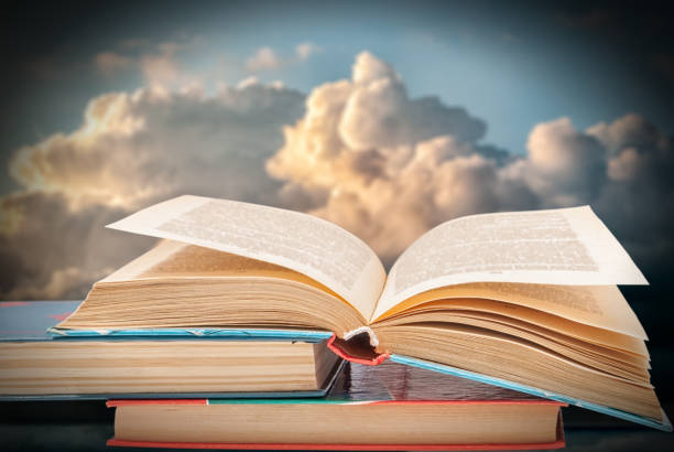 istock books against the blue sky with clouds 1133134672