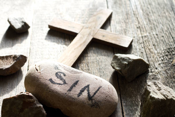 Cross made of white stones in a small french countryside graveyard