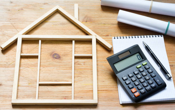 istock Remodeling construction valuation of home renovation abstract with calculator and plans 1133135951