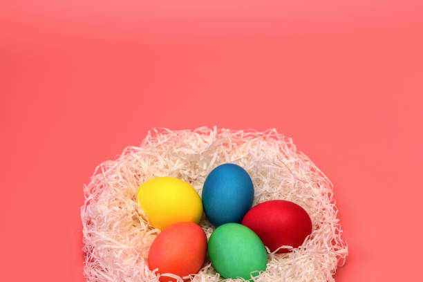 istock Five Easter colored eggs lie in the nest at the bottom on a soft pink background, on top there is a place for the inscription. Horizontal photo. 1133135969