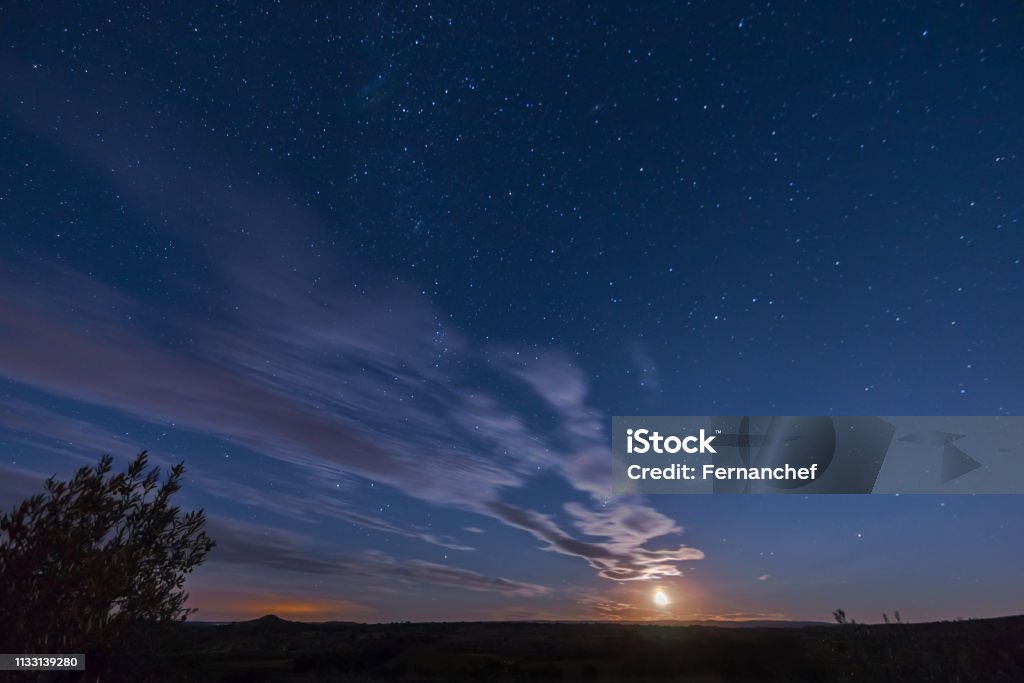 Stars and moon Night photography of Long exposure on a summer night in Castilla la Mancha Spain Astronomy Stock Photo