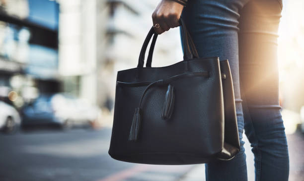 Closeup shot of a businesswoman walking with her handbag in the city