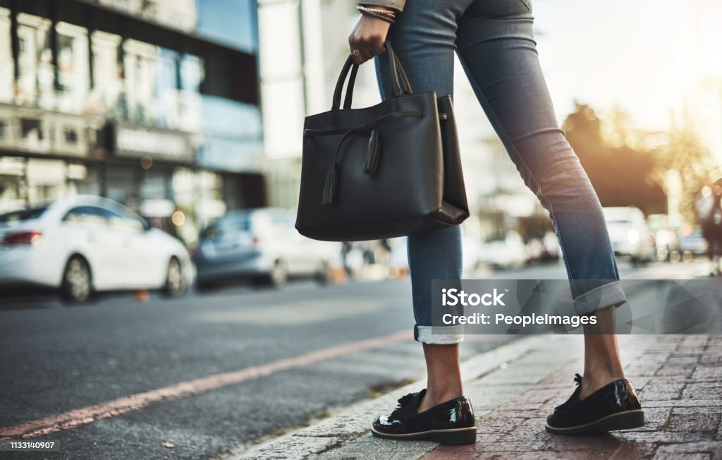 Show the city what you're made of Closeup shot of a businesswoman walking with her handbag in the city Purse Stock Photo