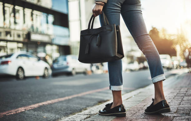 Show the city what you're made of Closeup shot of a businesswoman walking with her handbag in the city bag stock pictures, royalty-free photos & images