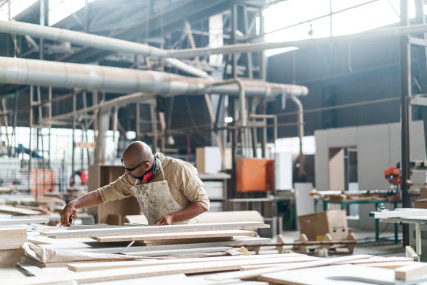 istock Skilled craftsman measuring wood on workbench 1133142486