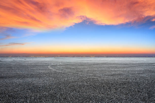 istock Empty asphalt ground and city skyline with beautiful clouds at sunset 1133144920