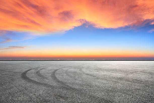 istock Empty asphalt ground and city skyline with beautiful clouds at sunset 1133144946