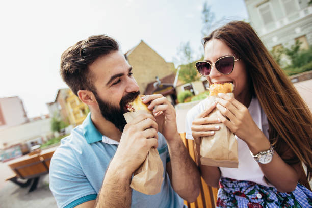 istock Young couple is eating sandwiches and having a great time 1133147599