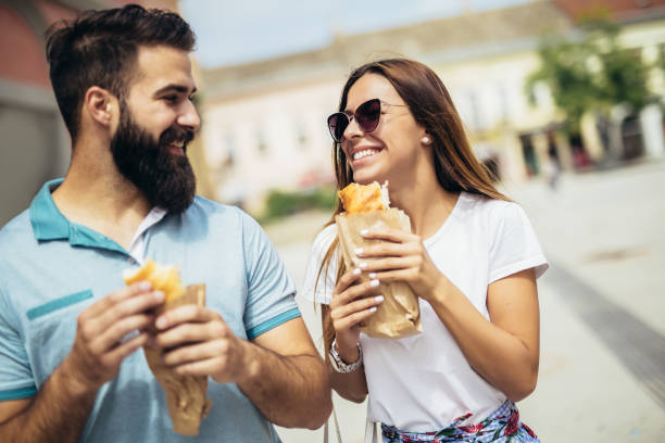 istock Young couple is eating sandwiches and having a great time 1133147637