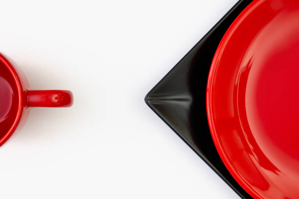 istock Different  red and black plates and red cup on the white table. 1133148014