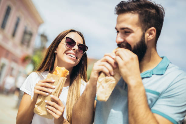 istock Young couple is eating sandwiches and having a great time 1133148074