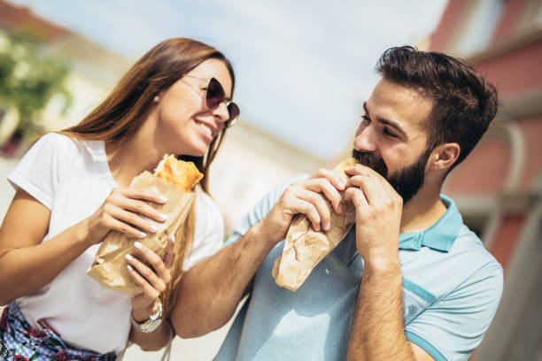 istock Young couple is eating sandwiches and having a great time 1133150089