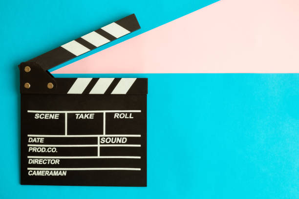 Flat lay of clapperboard against blue background.