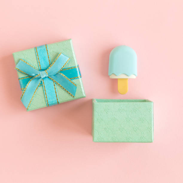istock Flat lay of gift box and ice cream miniature abstract on rose. 1133151176