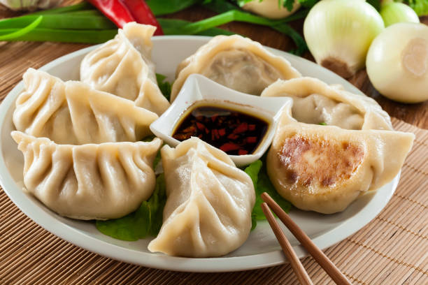 Japanese dumplings - Gyoza with pork meat and vegetables Japanese dumplings - Gyoza with pork meat and vegetables on a plate chinese food photos stock pictures, royalty-free photos & images