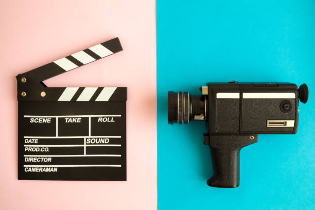 Clapperboard and vintage video camera on multicolored background. Flat lay of clapper board and retro camcorder on pastel background minimal creative concept. vintage video camera stock pictures, royalty-free photos & images