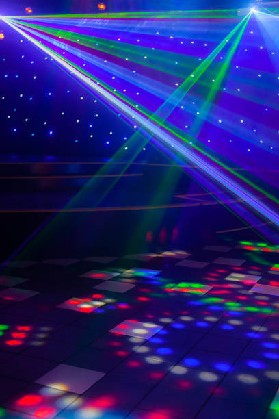Night club laser lights making patterns on the dance floor in Australia with a stage setting in the background. Inspiration for Mardi Gras or nightlcub promotions. Close up of night club laser lights series from Australian gay bar and nightclub with a stage setting in the background. dance floor stock pictures, royalty-free photos & images