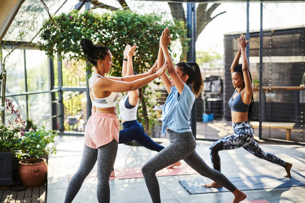 istock Instructor teaching Warrior Pose to females 1133154966