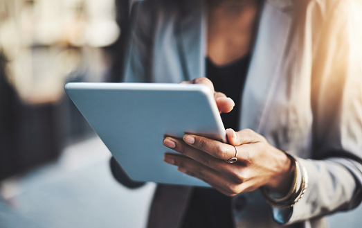 Closeup shot of a businesswoman using a digital tablet in the city