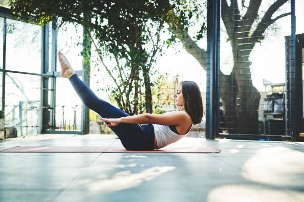 istock Side view of young woman practicing Boat Pose 1133155898