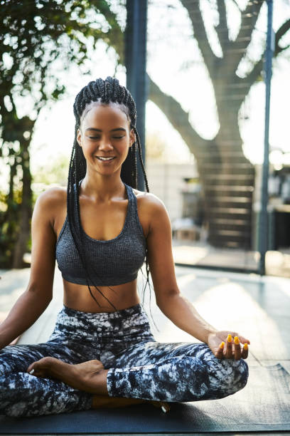 istock Smiling young woman practicing lotus position 1133156048