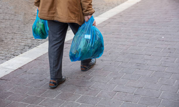 istock Man hoding blue plastic bags. Closeup view, copy space 1133157032