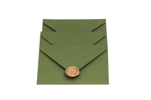istock green envelope with designer cardboard and seal on a white background. Envelope with seal 1133157583