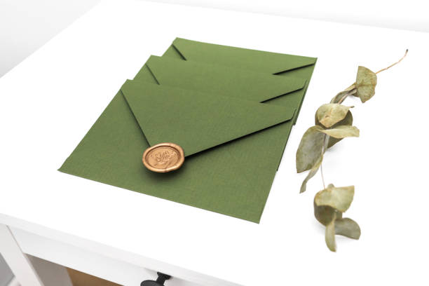 istock green envelope with designer cardboard and seal on a white background. Envelope with seal 1133157593