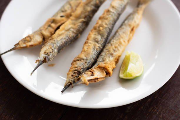 istock Agulha frita (typical fried fish from Pernambuco beaches, Brazil northeast) ready to eat as aperitif with a lemon slice to squeeze 1133158979