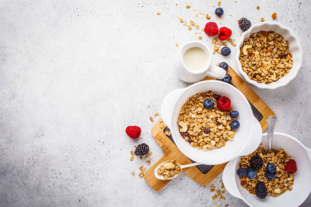 istock Breakfast food background. Granola with milk and berries on white table. 1133161176