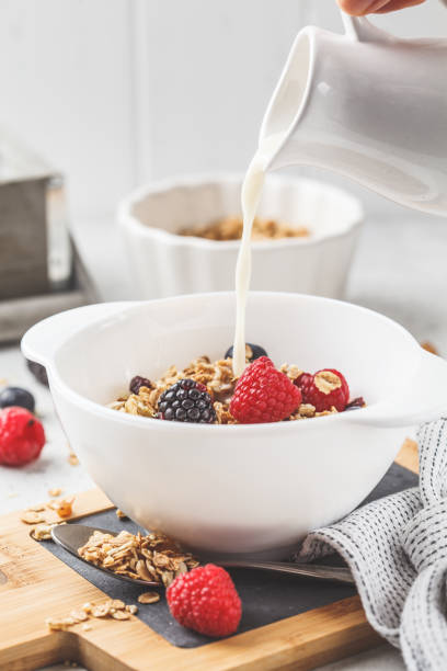 istock Breakfast food background. Granola with milk and berries on white table. 1133161743