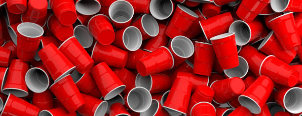 istock Plastic red color disposable cups pile background, texture, banner. 3d illustration 1133161776