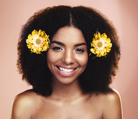 Studio shot of a beautiful young woman posing with flowers in her hair