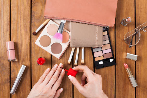 istock Makeup products with woman doing nail polish 1133163195