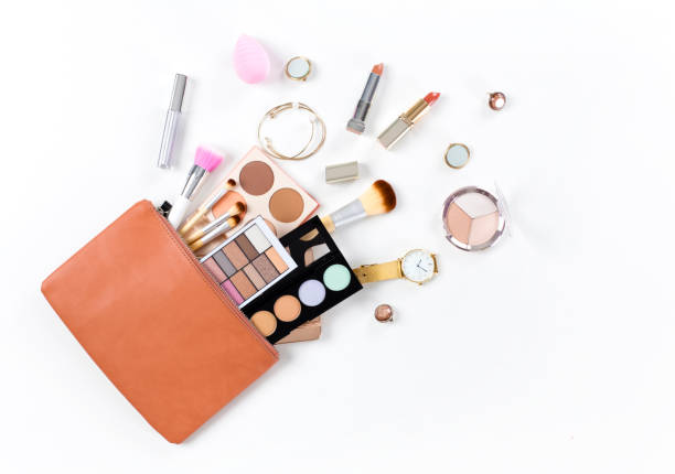 Makeup bag with cosmetic products Makeup bag with cosmetic products spilling out on to a isolated white background make up bag stock pictures, royalty-free photos & images