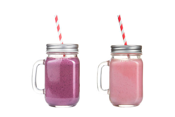 istock Fruit smoothies in glass jars on a white background. 1133165489
