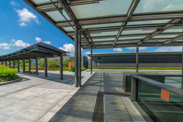 istock Modern glass elevator and pedestrian stairway entrances. 1133166541
