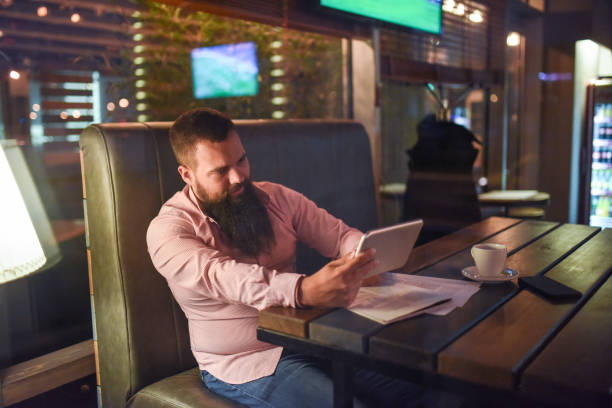 istock Businessman in a restaurant with a tablet 1133168025