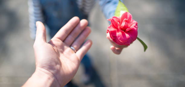 Parent and child handing flower