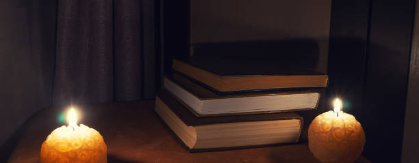 istock books on the table lit with night lights and candles 1133170407
