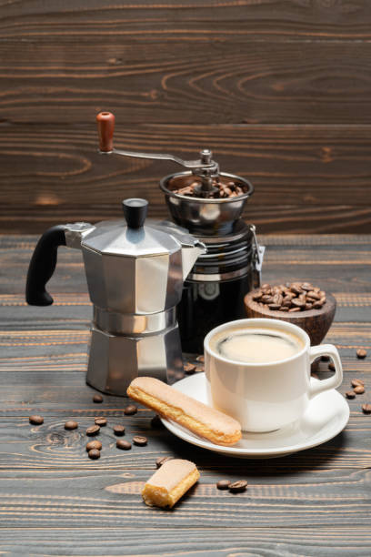 istock Cup of coffee with coffe maker on wooden backround 1133170643