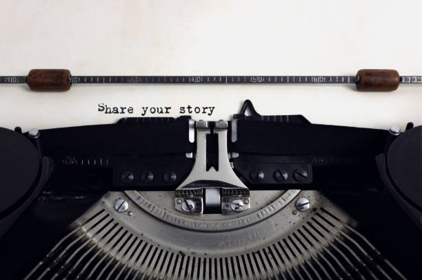 istock Old retro vintage black typewriter with close-up typing text Share your story as heading on aged paper 1133172338