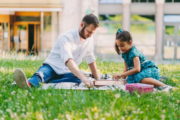 istock Father and daughter playing chess in the park 1133173263