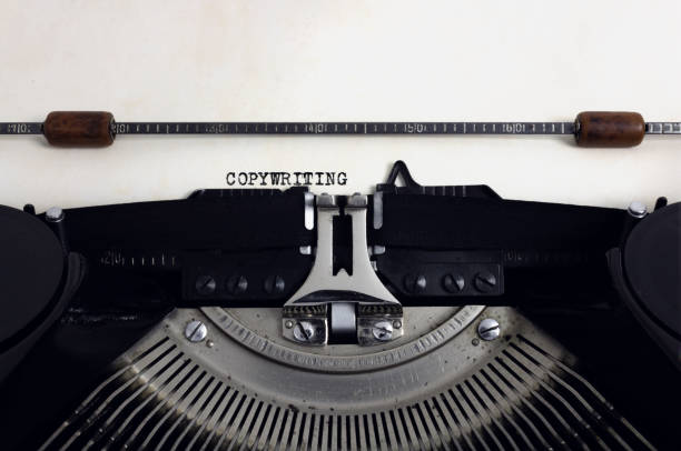 Old retro vintage black typewriter with close-up typing text Copywriting as heading on aged paper Old retro vintage black typewriter with close-up typing text Copywriting as heading on aged paper copywriter photos stock pictures, royalty-free photos & images