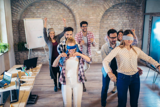 istock Business people making team training exercise during team building seminar, play a game of trust 1133176080